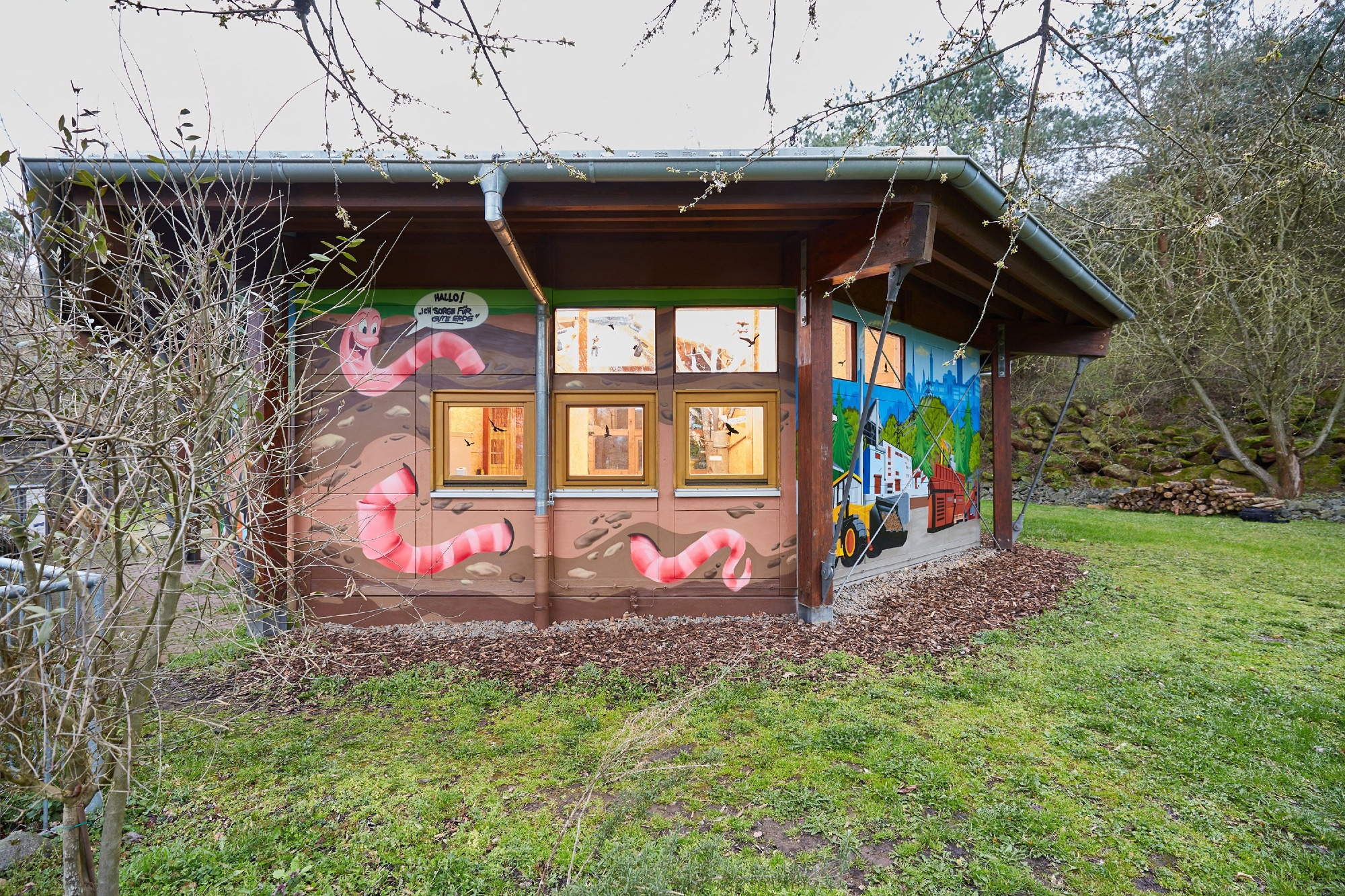 ZAK Freilandklassenzimmer mit bunten Wandmalereien für Umweltbildung und Naturpädagogik im Grünen