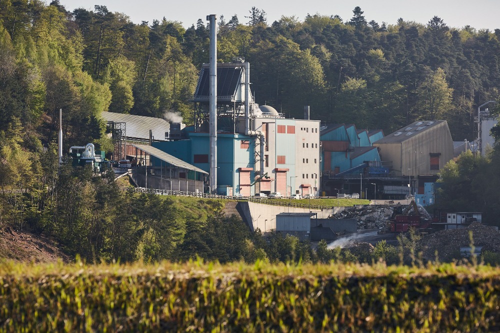 ZAK Abfallwirtschaftszentrum Kapiteltal mit Biomasseheizkraftwerk und Anlagengebäuden in bewaldeter Tallandschaft